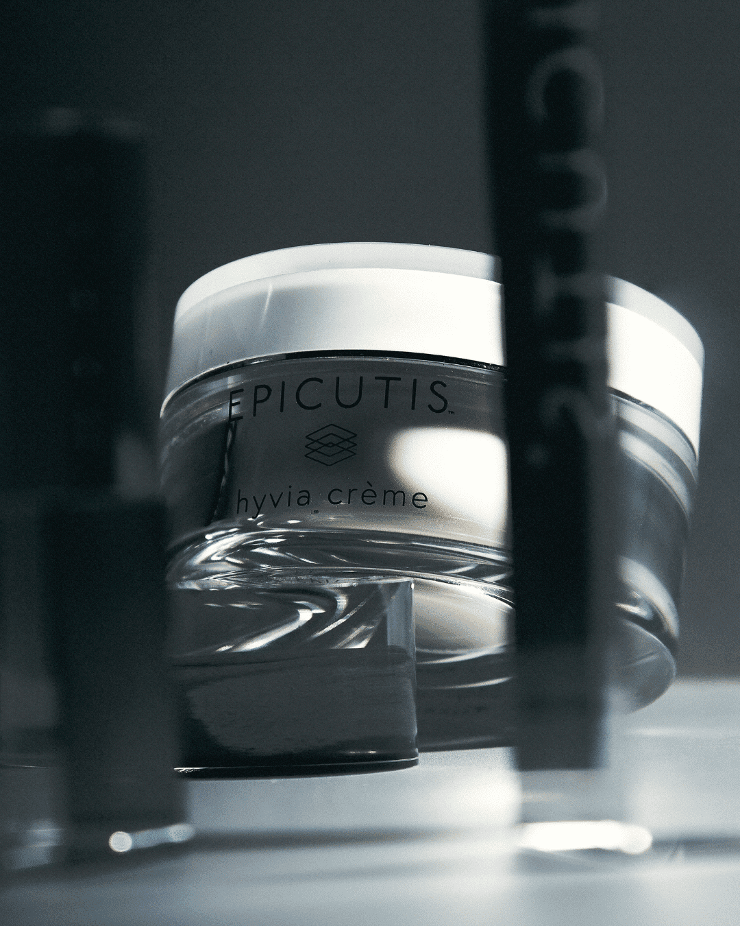 Luxurious Epicutis Hyvia Crème in a sleek jar, sharply focused against a blurred background.