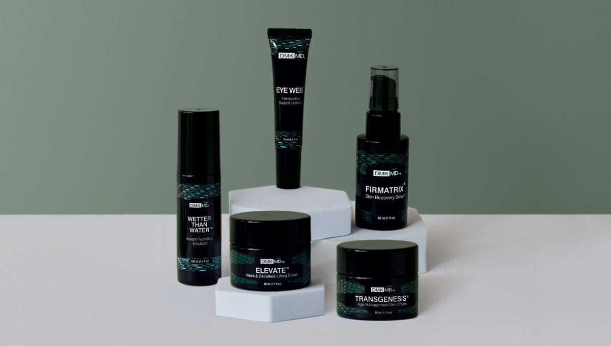 Skincare products on display, including creams, spray, and serum against a green background.